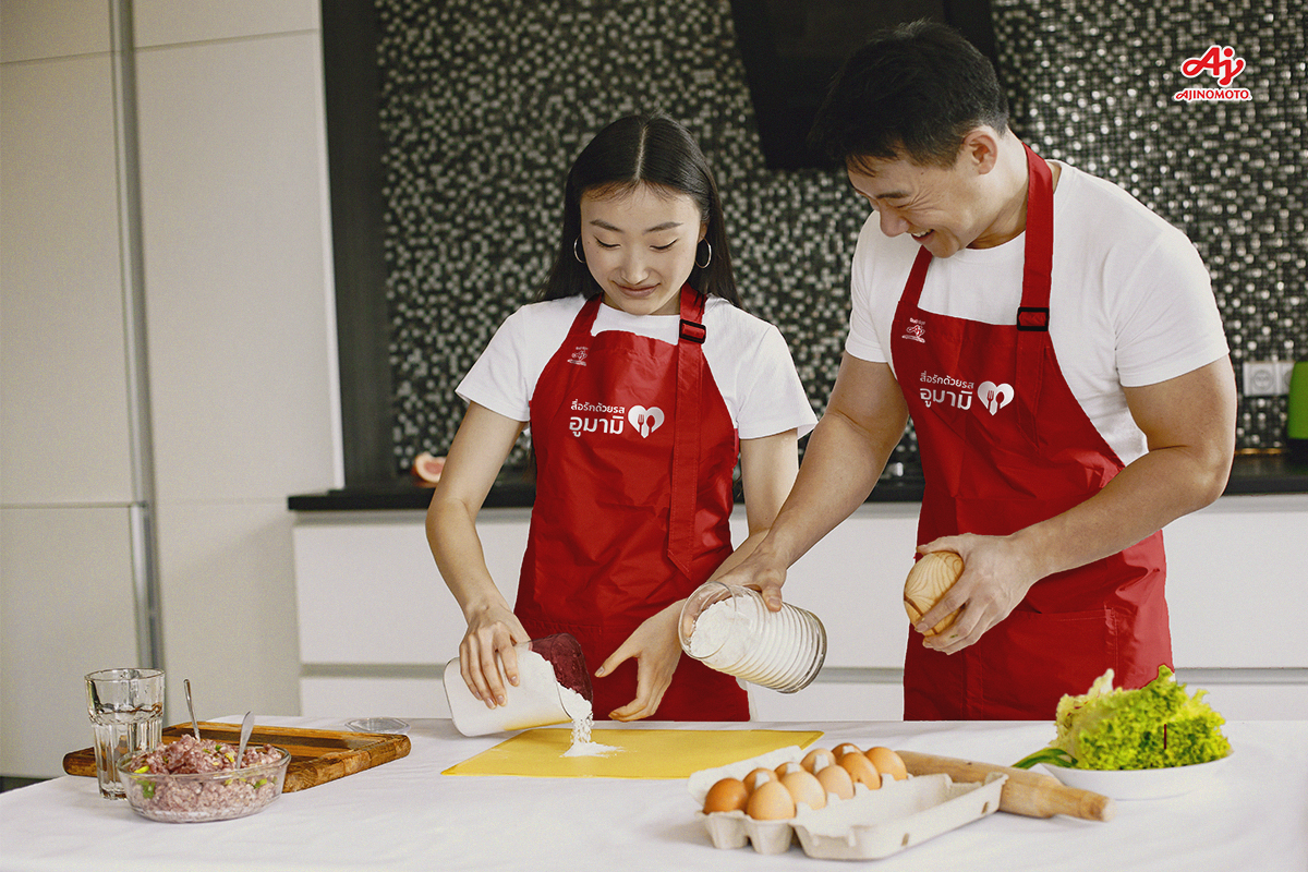 Happy asian couple have fun in modern kitchen indoor